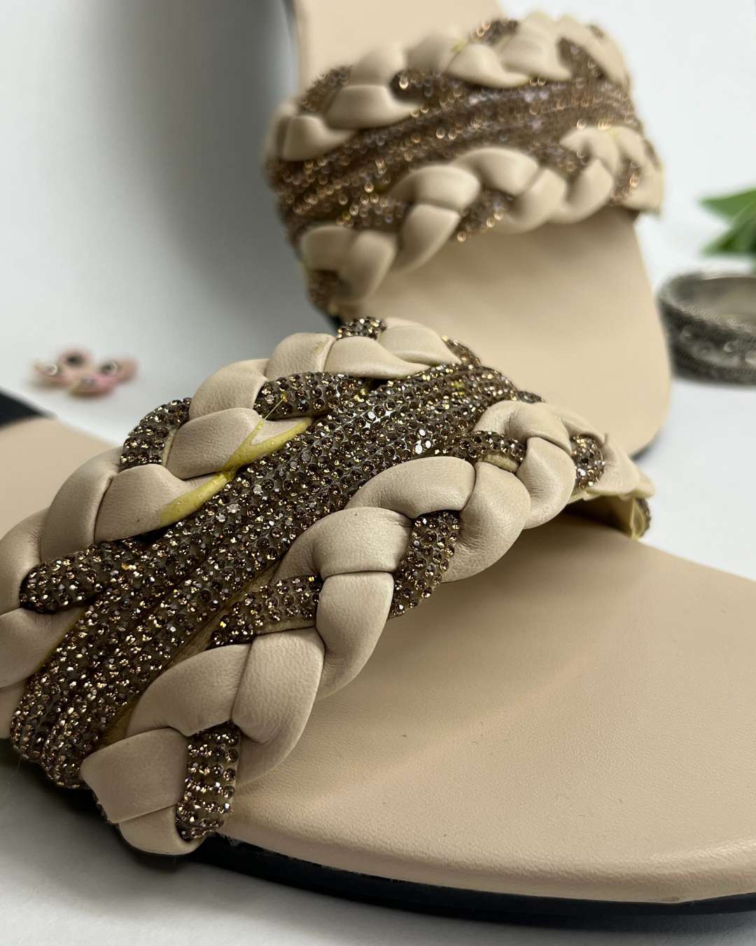 Women braided flats with crystal detailing and elegant design on a light background