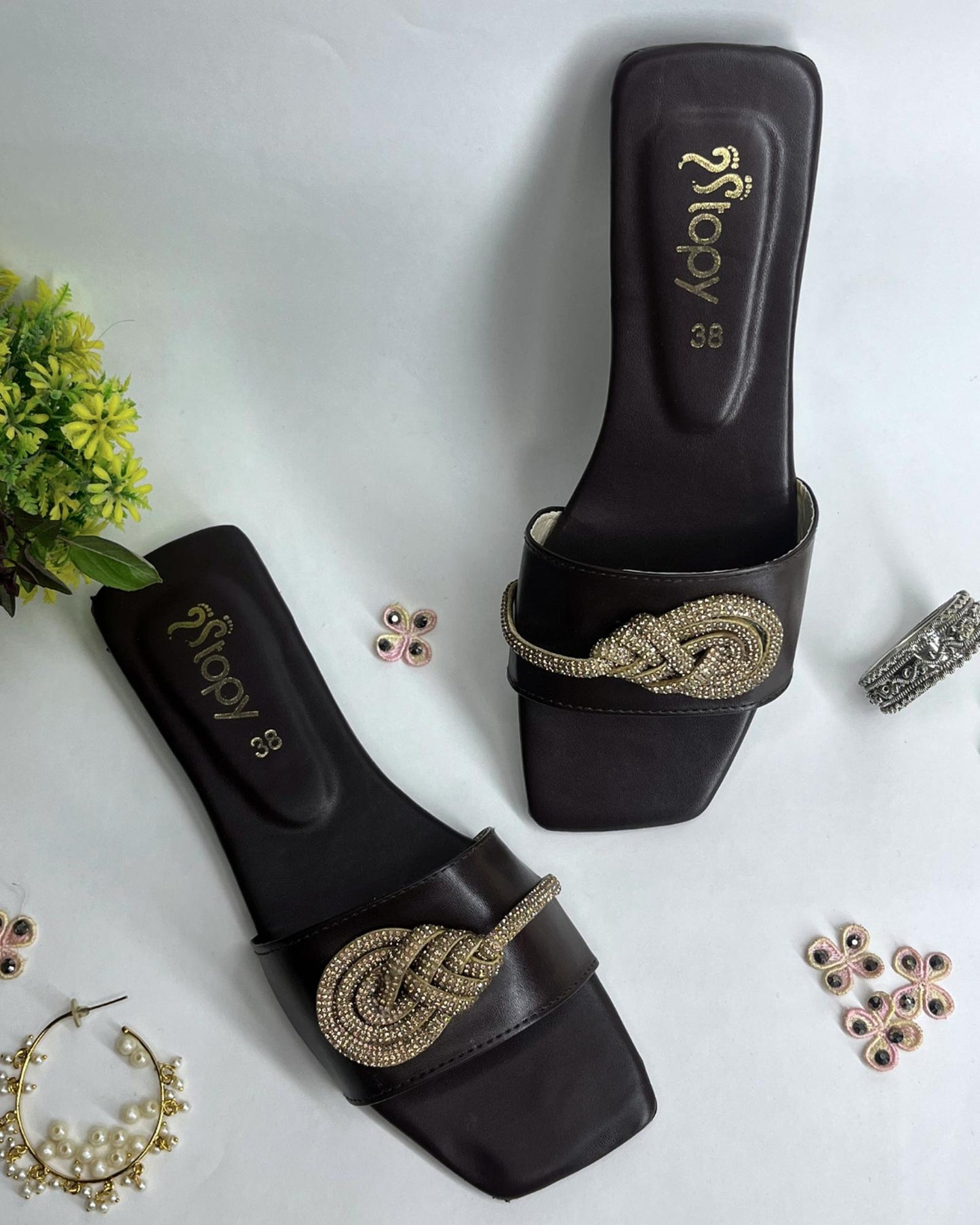 Dark brown women flats featuring crystal knot embellishment