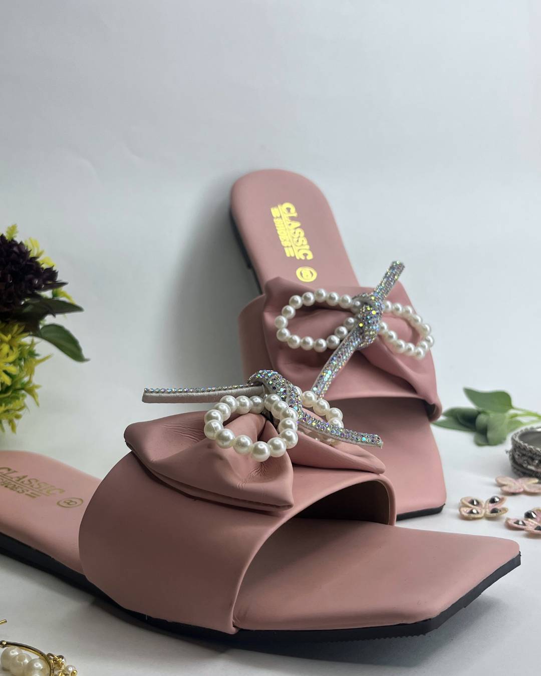 Pink women luxe flats featuring pearl bow embellishment