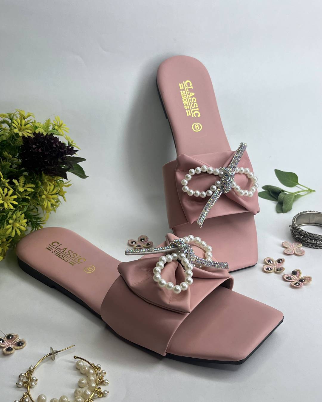 Pink women luxe flats featuring pearl bow embellishment
