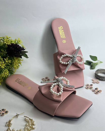 Pink women luxe flats featuring pearl bow embellishment