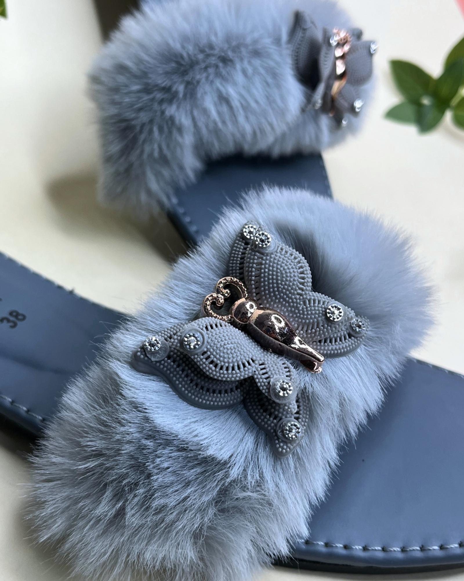 Blue Gucci style fluffy fur strap women slides with metallic detail on a light background